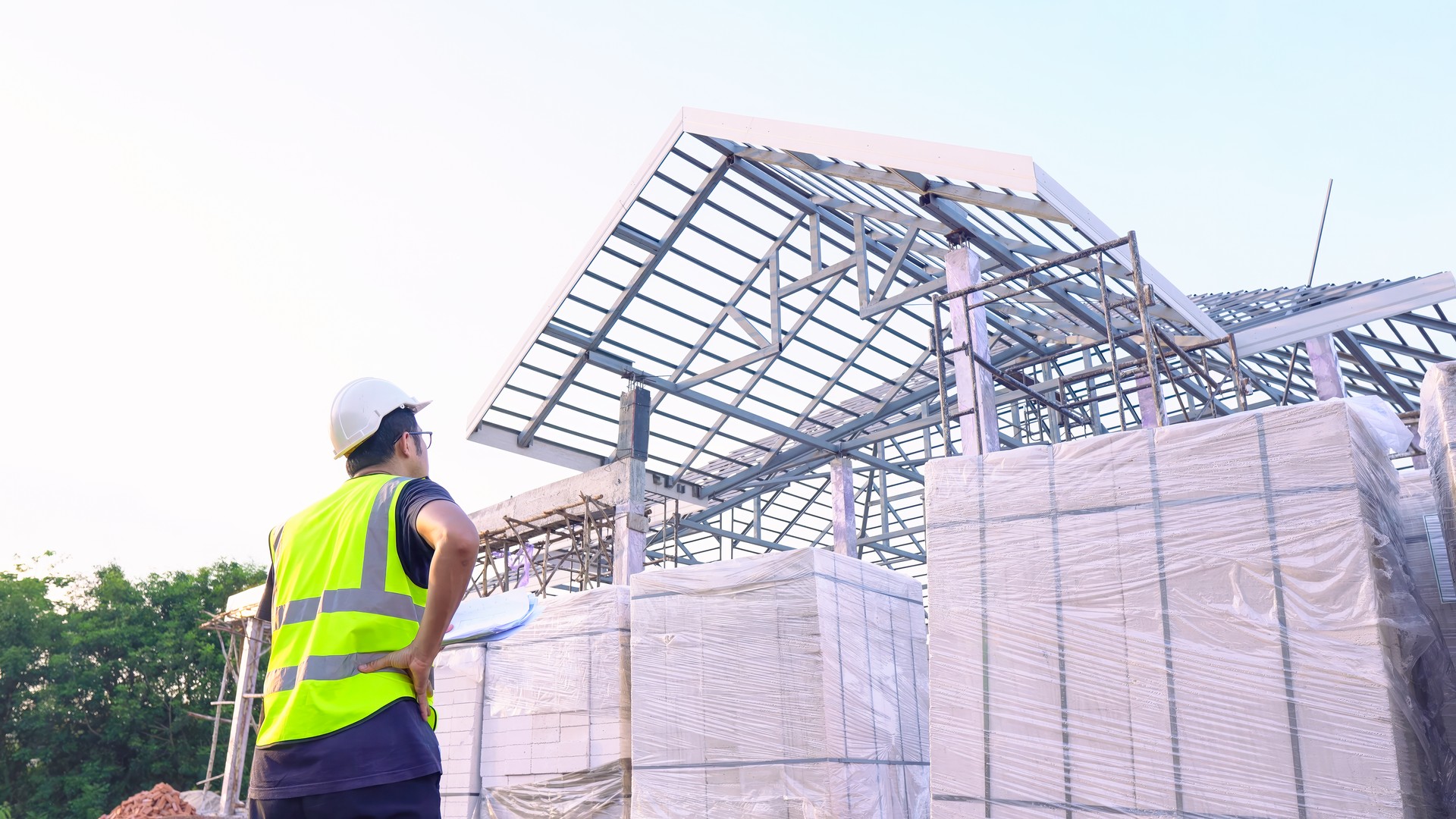 Asian male engineer control and checking Lightweight brickquality work at construction site.